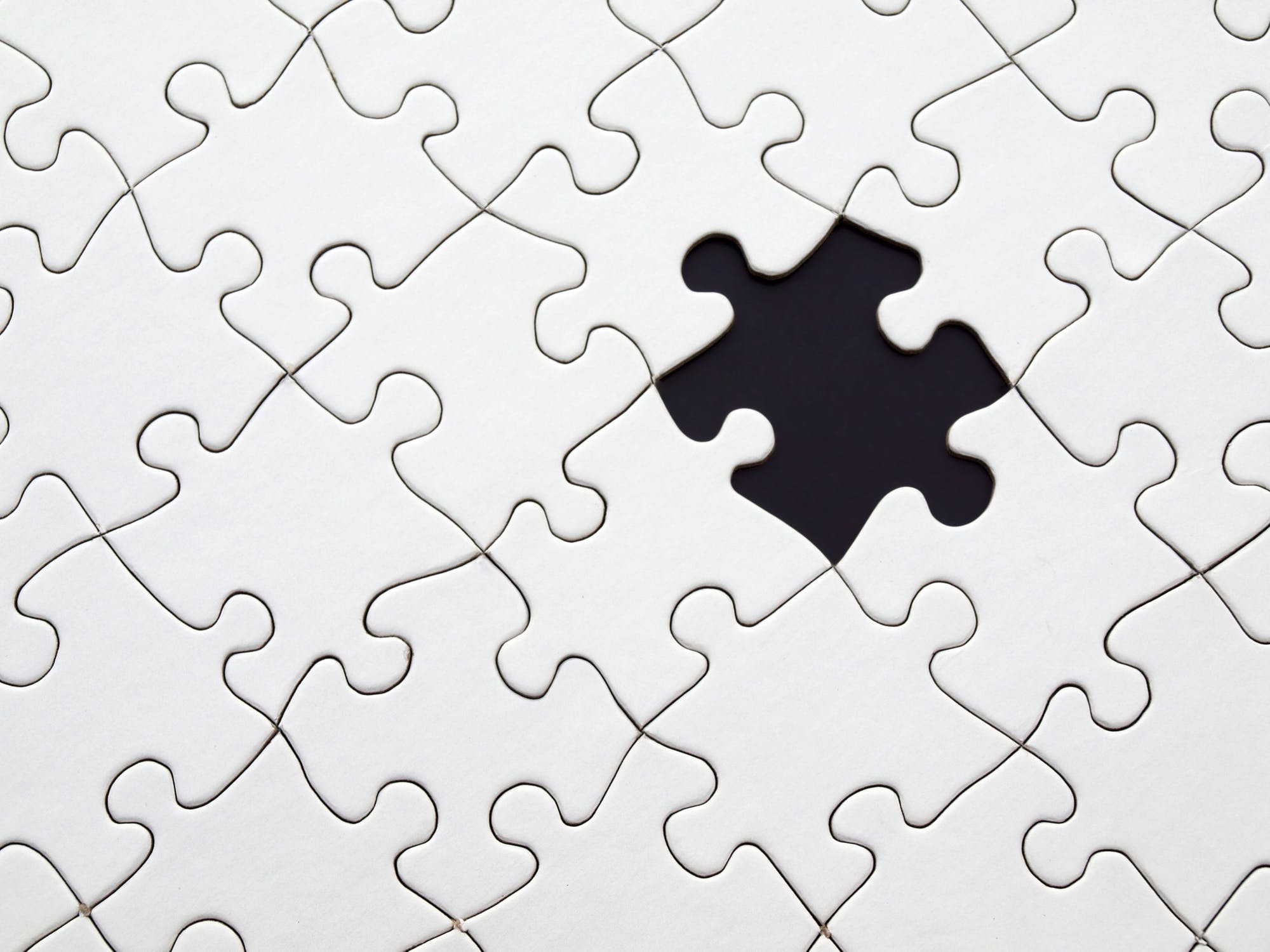 A white puzzle with a missing piece - CRM platform vs point solutions.