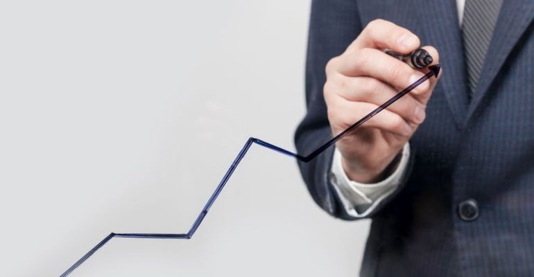 Businessman drawing a scaling line with a marker.