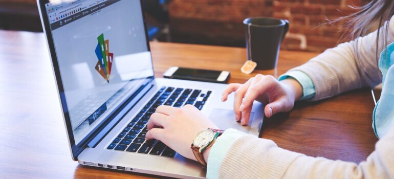 A woman typing on a laptop.