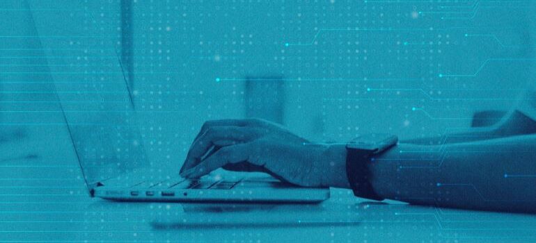 Person typing on laptop.