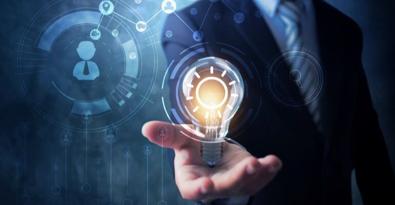 Businessman holding a lightbulb with AI in the background.