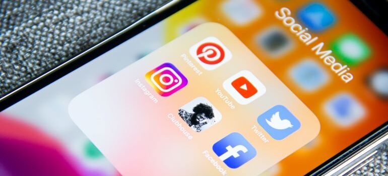 A smartphone with social media icons on its screen.