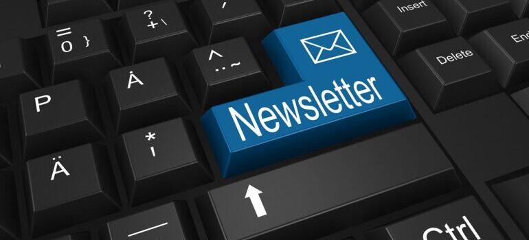 A black keyboard with a blue button named "Newsletter".