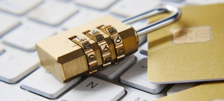 A lock sitting on a laptop.