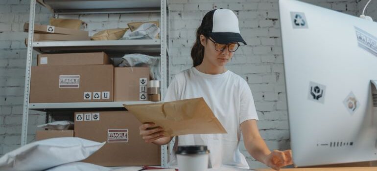 Female employee looking at laptop and taking inventory.