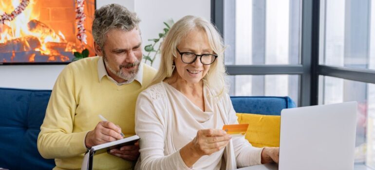 Older couple making an online purchase.