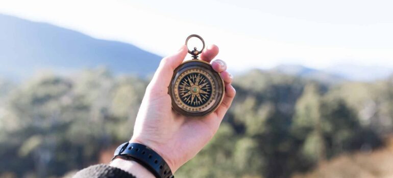 A person holding a compass.