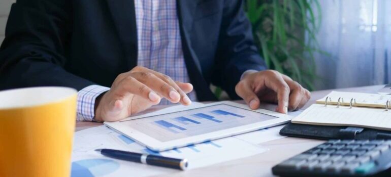 A person looking at a perfomance report on a tablet.