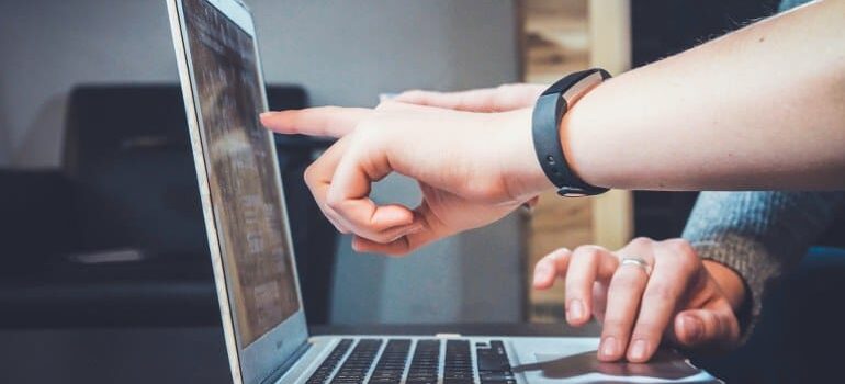 A person pointing to a CRM database.