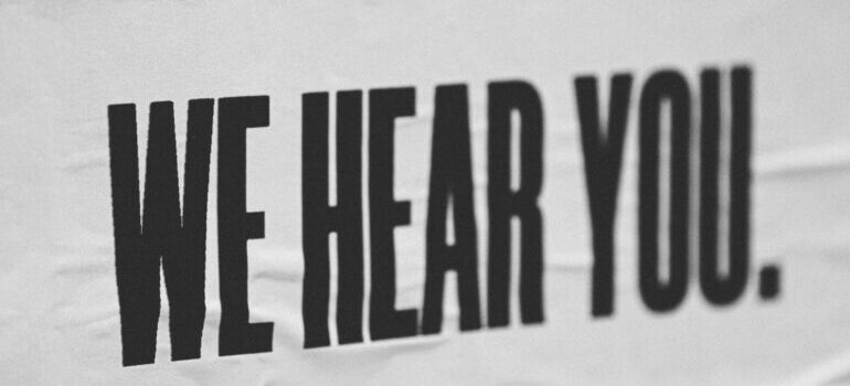 A sign saying WE HEAR YOU.