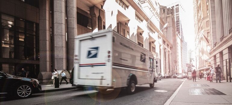 A delivery truck going down a road.