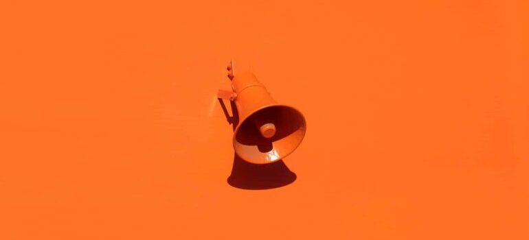 An orange megaphone on an orange background.