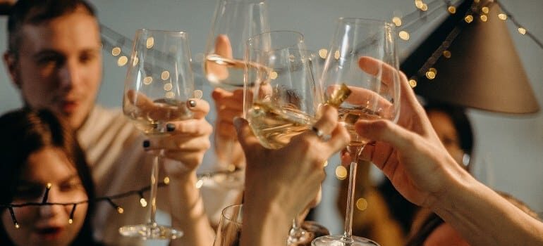 Office workers celebrating after they've managed to unify sales and marketing teams.