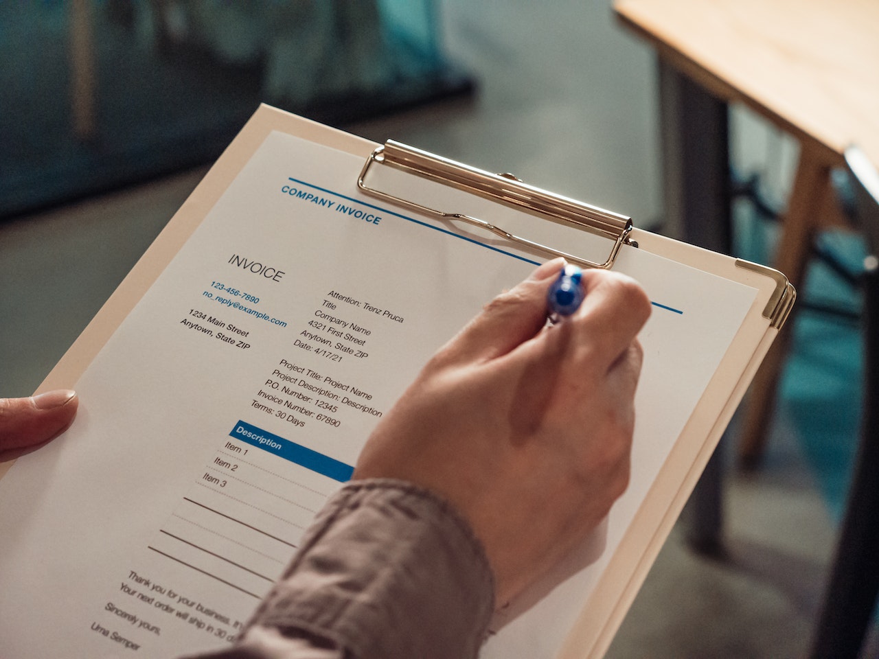 A person handling an invoice, representing the benefit of billing and invoicing with a cloud-based CRM.