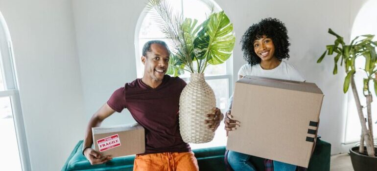 People carrying moving boxes.