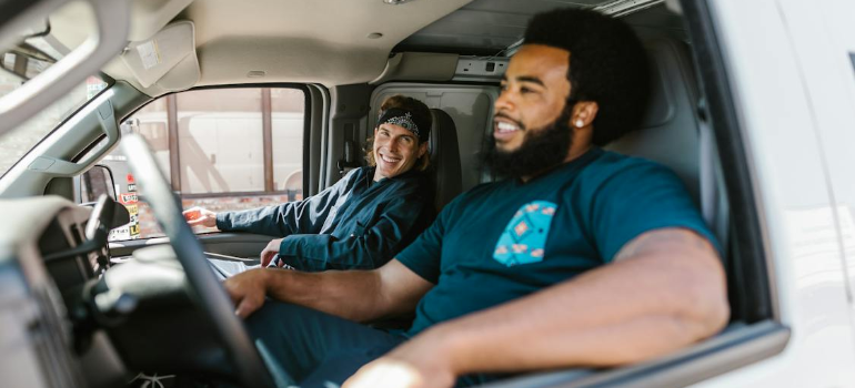 Two moving workers discussing money management tips for movers